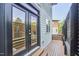 Inviting back porch featuring a wooden deck, glass doors, and lattice accents at 931 Ramseur St, Durham, NC 27701