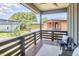 Inviting balcony with outdoor seating, wood railings, ceiling fan, and neighborhood views at 931 Ramseur St, Durham, NC 27701