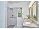 Bright bathroom features walk-in shower and granite countertop vanity at 931 Ramseur St, Durham, NC 27701