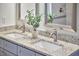 Bathroom vanity featuring granite countertops, double sinks, framed mirrors, and brushed metal faucets at 931 Ramseur St, Durham, NC 27701