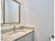 Bright bathroom with granite countertop vanity and decorative mirror at 931 Ramseur St, Durham, NC 27701