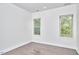 Bright, spacious bedroom with hardwood floors and windows offering scenic outdoor views at 931 Ramseur St, Durham, NC 27701