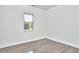 Clean and bright bedroom with hardwood floors, a window with blinds, and ample natural light at 931 Ramseur St, Durham, NC 27701