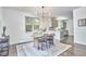 Open dining room with a view of the kitchen, featuring a modern chandelier at 931 Ramseur St, Durham, NC 27701