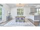 Dining area with modern chandelier, wooden table and gray accents at 931 Ramseur St, Durham, NC 27701