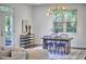 Bright dining room with a modern chandelier and large windows at 931 Ramseur St, Durham, NC 27701