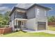 Modern two-story home featuring a two-car garage, a welcoming front porch, and a second-story balcony at 931 Ramseur St, Durham, NC 27701