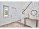 Inviting foyer with a staircase, stylish console table, mirror, and a modern front door at 931 Ramseur St, Durham, NC 27701