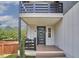 Close up of a charming front porch with stylish railings and a welcoming front door with a wreath at 931 Ramseur St, Durham, NC 27701