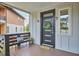 Charming front porch featuring a modern front door with a wreath, seating, and stylish decor at 931 Ramseur St, Durham, NC 27701