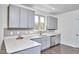 Bright kitchen featuring gray cabinets, stainless appliances, and quartz countertops at 931 Ramseur St, Durham, NC 27701