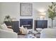 Cozy living room with a modern fireplace, stylish cabinets, a throw blanket, and an art piece at 931 Ramseur St, Durham, NC 27701