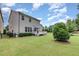 Spacious backyard featuring a well-maintained lawn, deck, and privacy landscaping at 1020 Regency Cottage Pl, Cary, NC 27518