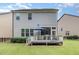 View of the backyard, featuring a well-maintained lawn, deck, and a covered patio at 1020 Regency Cottage Pl, Cary, NC 27518