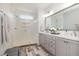 Modern bathroom with a glass shower, gray vanity, and decorative touches at 1020 Regency Cottage Pl, Cary, NC 27518