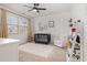 Charming Bedroom with a crib, decorative white wall, and large window at 1020 Regency Cottage Pl, Cary, NC 27518