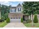 Charming two-story home with stone accents, a two-car garage, and landscaped front yard at 1020 Regency Cottage Pl, Cary, NC 27518