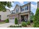 Beautiful two-story home featuring stone accents, a two-car garage, and a charming front porch at 1020 Regency Cottage Pl, Cary, NC 27518
