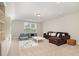 Spacious living room with recessed lights, a comfortable sofa, and a 'Play All Day' rug at 1020 Regency Cottage Pl, Cary, NC 27518