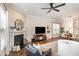Comfortable living room with fireplace, large television, and a view into the dining area at 1020 Regency Cottage Pl, Cary, NC 27518