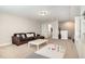 Inviting living room with a sectional sofa, white coffee table, and access to other rooms at 1020 Regency Cottage Pl, Cary, NC 27518