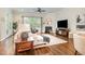 Inviting living room featuring a fireplace, ample seating, and large windows for natural light at 1020 Regency Cottage Pl, Cary, NC 27518