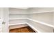 Walk-in pantry features ample shelving, offering plenty of storage space at 1020 Regency Cottage Pl, Cary, NC 27518