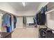 This walk-in closet offers tons of storage with rods and shelves at 1020 Regency Cottage Pl, Cary, NC 27518