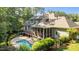 Beautiful backyard featuring a pool, screened in porch, mature trees, and plenty of space for outdoor entertaining at 1028 Harpers Ridge Ct, Wake Forest, NC 27587