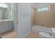 Bathroom with tub and shower surrounded by light brown tiles and a toilet at 1028 Harpers Ridge Ct, Wake Forest, NC 27587
