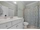 Bathroom featuring a vanity with white marble countertop and a patterned shower curtain at 1028 Harpers Ridge Ct, Wake Forest, NC 27587