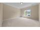 Empty bedroom featuring neutral walls and carpet with a large window at 1028 Harpers Ridge Ct, Wake Forest, NC 27587