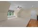 Expansive bonus room with carpet, ceiling fan, and natural light from the window at 1028 Harpers Ridge Ct, Wake Forest, NC 27587