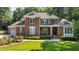 Charming two-story brick home featuring a well-manicured lawn, classic shutters, and inviting front entrance at 1028 Harpers Ridge Ct, Wake Forest, NC 27587
