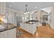 Large kitchen with stainless appliances, granite counters, and a stone fireplace at 1028 Harpers Ridge Ct, Wake Forest, NC 27587