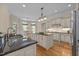 Open kitchen features granite countertops, an island, stainless appliances, and sunlit breakfast nook at 1028 Harpers Ridge Ct, Wake Forest, NC 27587