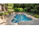 Custom pool is surrounded by stone, offering a secluded space for relaxation at 1028 Harpers Ridge Ct, Wake Forest, NC 27587