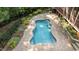 Inviting backyard pool with stone pavers and surrounded by professional landscaping at 1028 Harpers Ridge Ct, Wake Forest, NC 27587