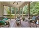 Relaxing screened porch with comfortable seating overlooking the beautiful backyard and pool at 1028 Harpers Ridge Ct, Wake Forest, NC 27587