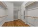 Spacious walk-in closet with wooden floor and built-in shelving for ample storage at 1028 Harpers Ridge Ct, Wake Forest, NC 27587