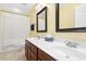 Bathroom featuring double sinks, wood cabinets, and tile floors at 10570 Evergreen Spring Pl, Raleigh, NC 27614
