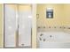 Bathroom featuring a shower, a jacuzzi bathtub, and mosaic tiling at 10570 Evergreen Spring Pl, Raleigh, NC 27614