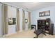 Well-equipped home gym with weight bench, shelving, and ample natural light at 10570 Evergreen Spring Pl, Raleigh, NC 27614