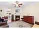 Cozy living room featuring a fireplace, hardwood floors, and comfortable seating area at 10570 Evergreen Spring Pl, Raleigh, NC 27614