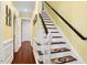 Bright staircase with hardwood floors and decorative runner leading to the upper level at 10570 Evergreen Spring Pl, Raleigh, NC 27614