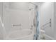 White tiled tub and shower combination with accessibility hand rails at 108 Ellsworth Pl, Cary, NC 27511