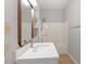 Bathroom vanity and shelving, with view into the shower at 108 Ellsworth Pl, Cary, NC 27511