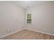 Bedroom with bright window and neutral paint and wood-look flooring at 108 Ellsworth Pl, Cary, NC 27511