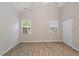 Bright bedroom with vaulted ceiling, two windows, closet, and wood-look flooring at 108 Ellsworth Pl, Cary, NC 27511
