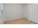 Neutral bedroom with wood-look flooring and a bright window with natural light at 108 Ellsworth Pl, Cary, NC 27511